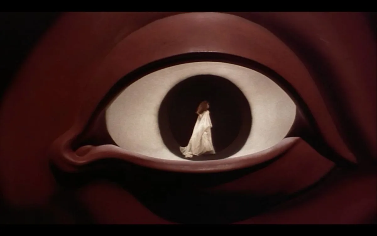 Giant eye with a figure walking inside — voyeurism